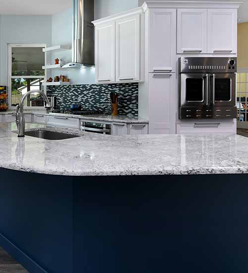 Cayhill Cabinets in Backround in Pearl Opaque and Island with Blue Lagoon Opaque